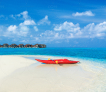 美丽的热带海滩，在异国情调的岛屿上有白色的沙滩、碧绿的海水和蓝天。热带海滩上的皮划艇